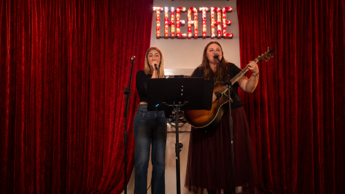 Jasmine Green and Callysta van Niekerk performing on stage as The Dolls